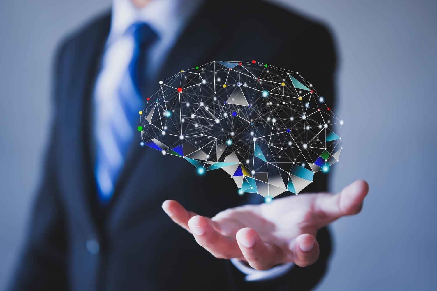 A man holding a hologram of the brain with neurons outlined by colored dots
